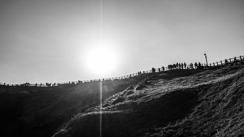 Scenic view of land against sky on sunny day