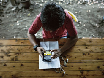 High angle view of man using mobile phone