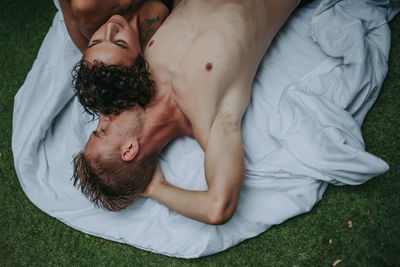 High angle view of man lying on bed