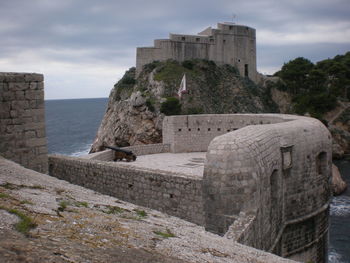 Old ruin building against cloudy sky