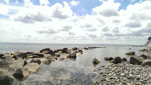 Scenic view of sea against cloudy sky