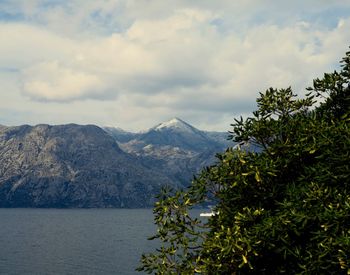 Scenic view of mountains against cloudy sky