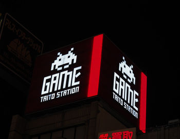 Low angle view of information sign at night