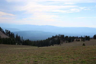 Scenic view of mountains against cloudy sky