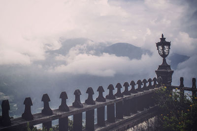 Scenic view of clouds covering mountains seen from balcony