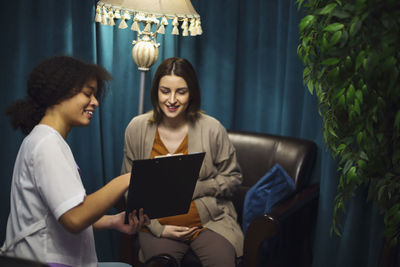 Young woman using laptop at home