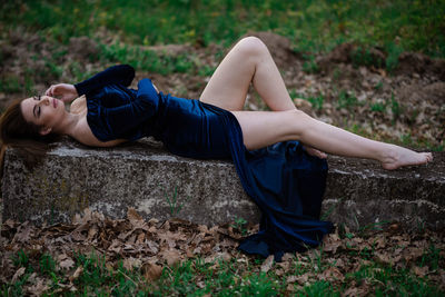 Young woman lying down on land