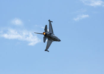 Low angle view of airplane flying against sky