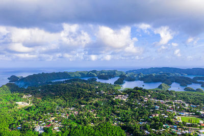 High angle view of city by sea against sky