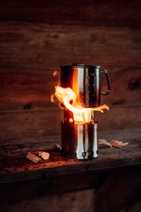 Close-up of burning candles on wooden table