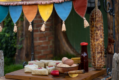 Clothes hanging in basket on table against building