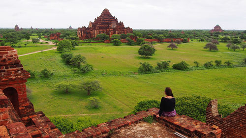 Rear view of man standing on old ruins