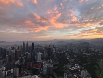 High angle view of buildings against cloudy sky during sunset