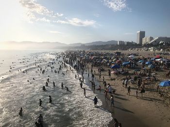 High angle view of people at beach against sky