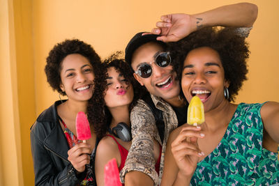 Portrait of smiling young woman holding ice cream