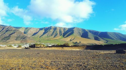 Scenic view of mountains against cloudy sky