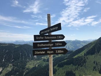 Information sign on mountain against sky - alps austria