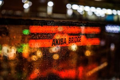 Close-up of text on wet window at night