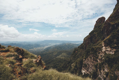 Scenic view of mountains against cloudy sky