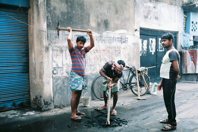 Young men standing on wall