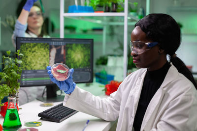 Scientist holding petri dish at laboratory