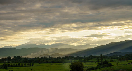 Scenic view of field against sky during sunset