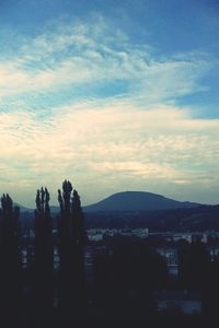 Scenic view of mountains against cloudy sky