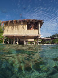 Built structure on beach against blue sky