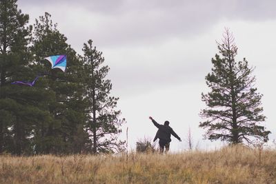 Man standing on field against sky