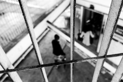 High angle view of people walking on railroad tracks by building