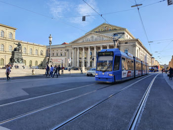 View of city street and buildings against sky