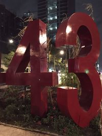 Close-up of hand in illuminated city