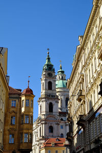Low angle view of buildings against clear blue sky