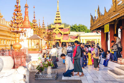 Group of people outside temple against building