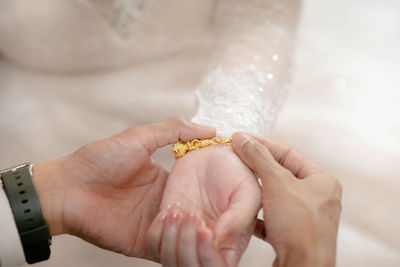 Midsection of woman holding wedding dress