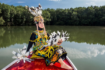 Rear view of woman in boat in lake