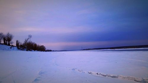 Scenic view of lake against sky during winter