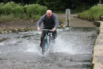 Full length of a man holding water