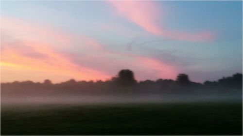 Scenic view of landscape against sky at sunset