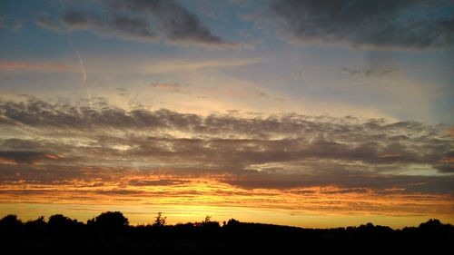 Silhouette landscape against sky during sunset