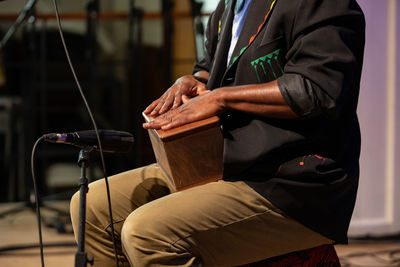 Side view of man sitting on chair