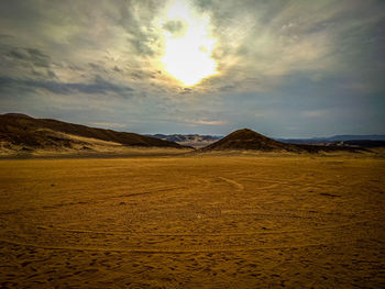 Scenic view of desert against sky during sunset