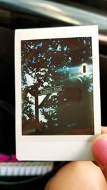 Reflection of person photographing in mirror