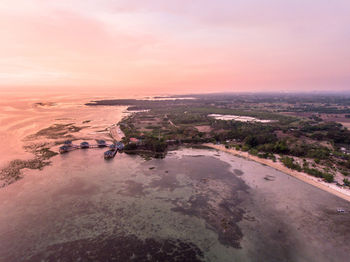 Aerial view of sea against sky at sunset