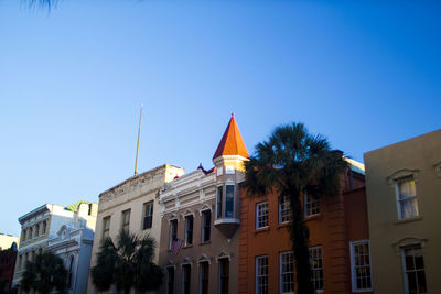 Low angle view of buildings against clear blue sky