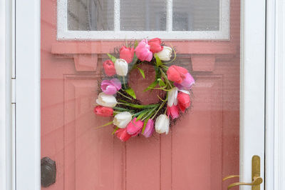 Pink flower pot on window
