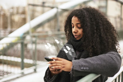 Woman reading fake news on cell phone