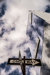 Low angle view of road sign against sky