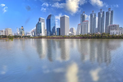 Reflection of buildings in city against sky