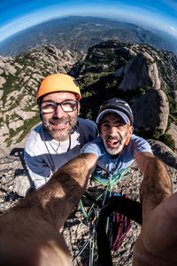 Selfie of two climber on peak of montserrat mountain
